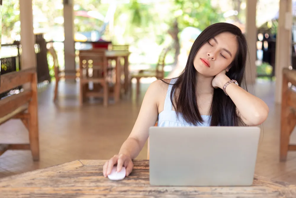 woman with neck pain while working